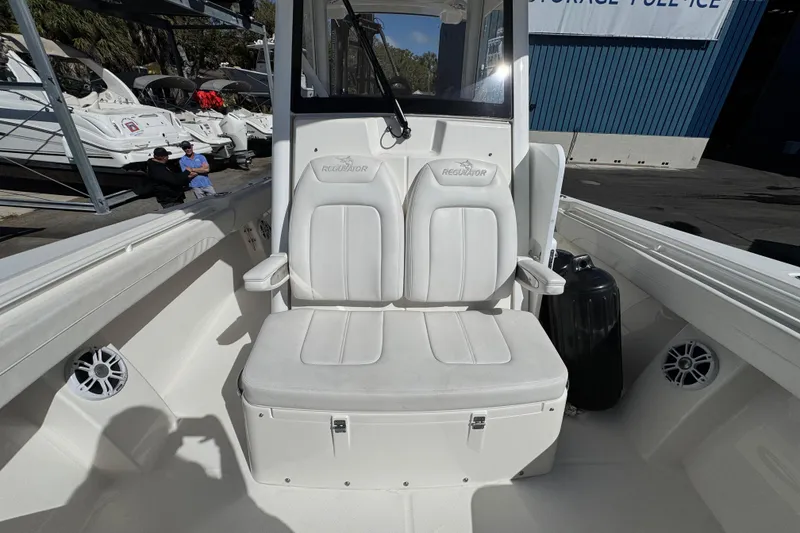 Slide: The Image of 2023 Regulator 31 boat interior with white seating and storage area. - 23