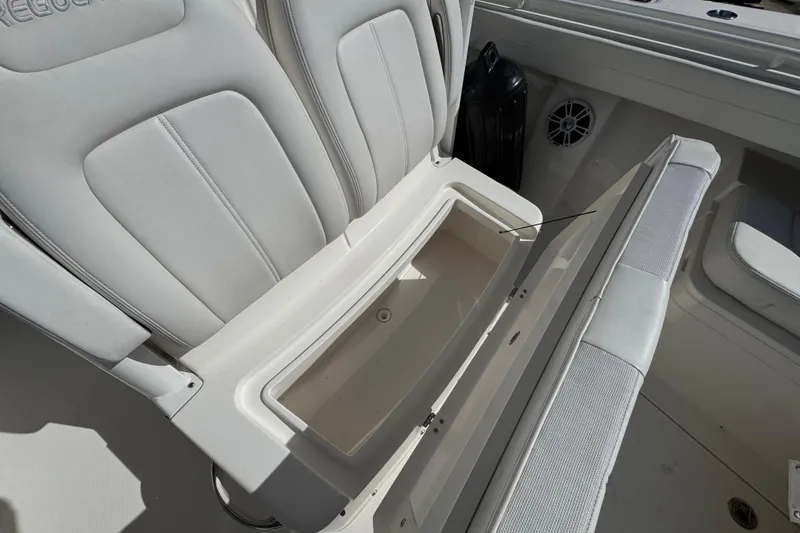 Slide: The Image of 2023 Regulator 31 boat seat with storage compartment open, showcasing interior design. - 24