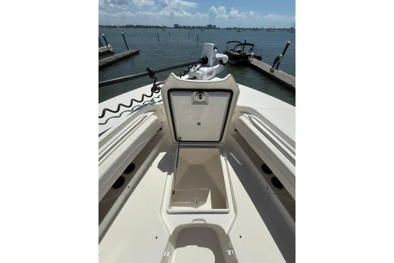 Slide: The Image of 2023 Regulator 31 boat with open storage compartment, docked by the water. - 31