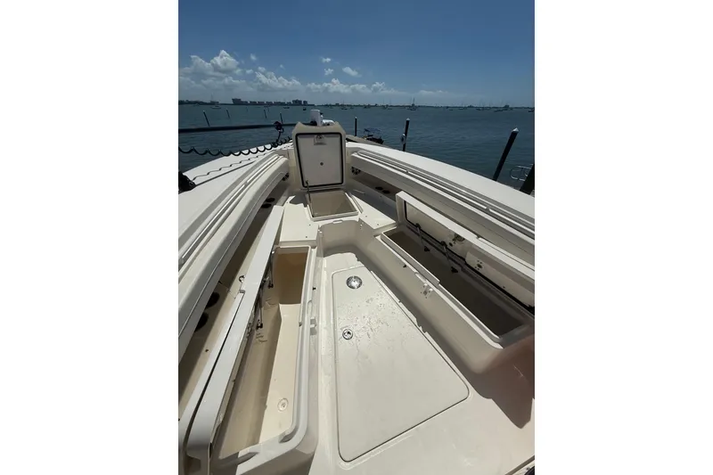 Slide: The Image of 2023 Regulator 31 boat interior with open storage compartments, docked by the water. - 33