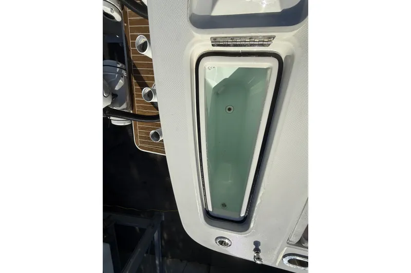 Slide: The Image of 2023 Regulator 31 boat deck with storage compartment and rod holders. - 36