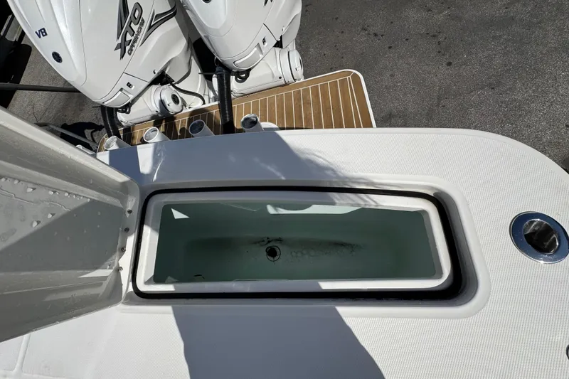 Slide: The Image of 2023 Regulator 31 boat with open livewell and twin outboard engines. - 37