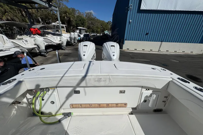 Slide: The Image of 2023 Regulator 31 boat with dual engines, docked near other vessels. - 5