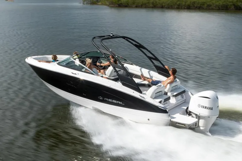 Slide: The Image of 2025 Regal LX4 boat in showroom, featuring sleek design and modern interior. - 1