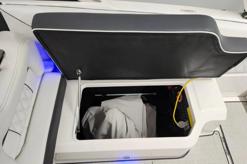 Slide: The Image of Open storage compartment in 2025 Regal LX4 boat with interior lighting. - 12