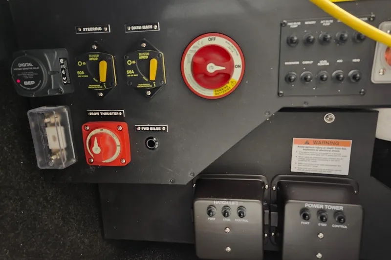 Slide: The Image of Control panel of a 2025 Regal LX4 boat with switches and warning labels. - 13