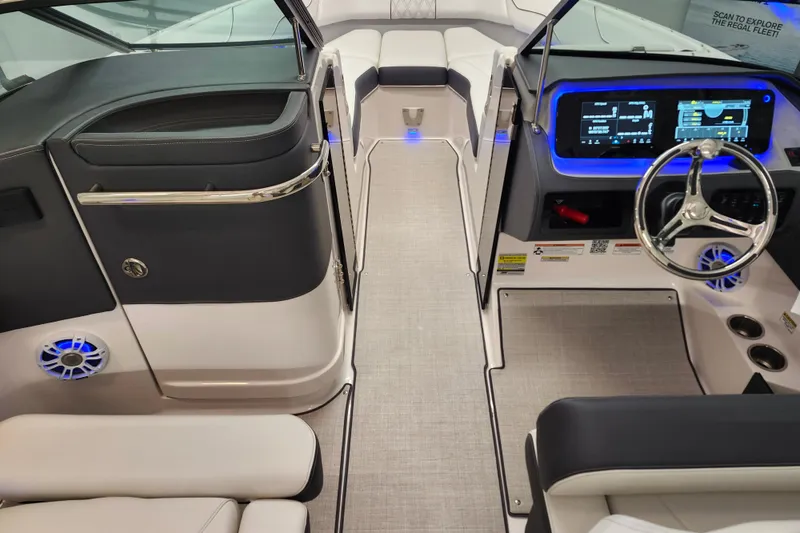 Slide: The Image of 2025 Regal LX4 boat interior with modern dashboard and sleek seating design. - 15