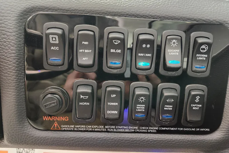 Slide: The Image of Control panel of 2025 Regal LX4 boat with various switches and warning label. - 17