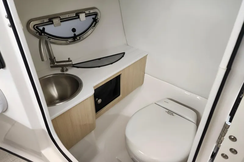 Slide: The Image of Compact bathroom in 2025 Regal LX4 boat with sink and toilet. - 19