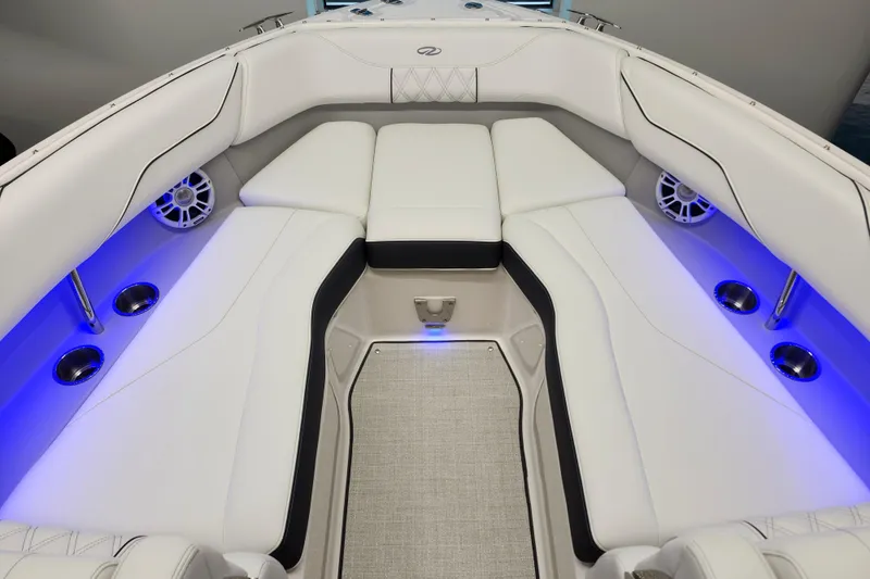 Slide: The Image of Luxurious interior of 2025 Regal LX4 boat with white seating and blue LED lighting. - 24