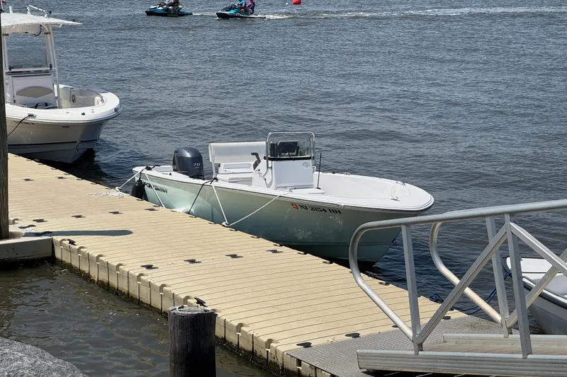 Slide: The Image of 2016 Sportsman Island Reef 17 Center Console docked by the water. - 12