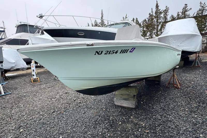 Slide: The Image of 2016 Sportsman Island Reef 17 Center Console boat on stands, gravel lot background. - 4
