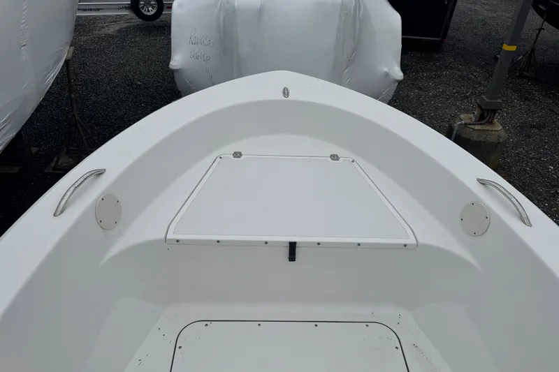 Slide: The Image of 2016 Sportsman Island Reef 17 Center Console boat, white interior, storage compartment visible. - 7