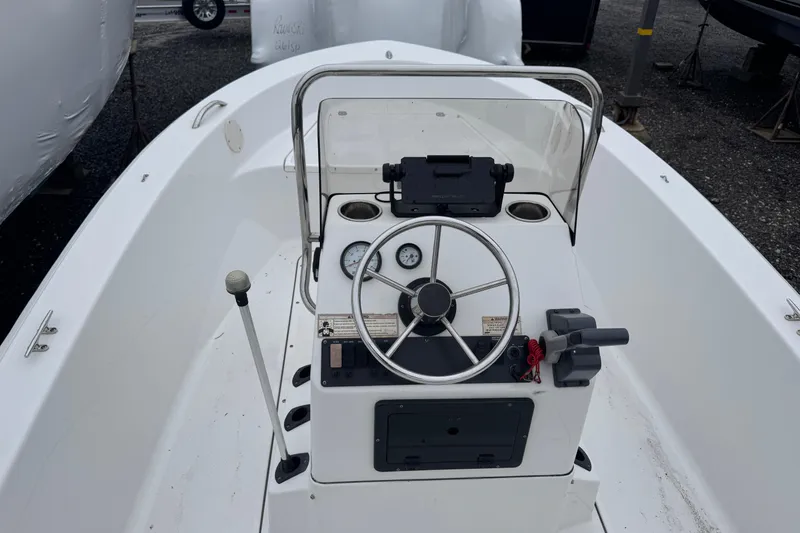 Slide: The Image of 2016 Sportsman Island Reef 17 Center Console boat interior with steering wheel and controls. - 8