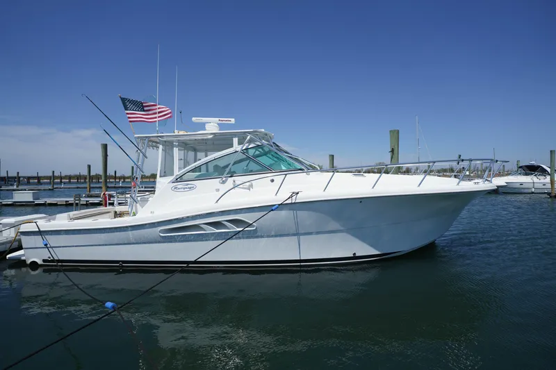 The Image of 2011 Rampage 41 Express yacht docked in marina, clear blue sky. - 0