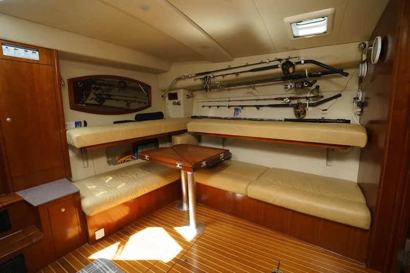 Slide: The Image of Interior of 2011 Rampage 41 Express boat with fishing rods and seating area. - 15