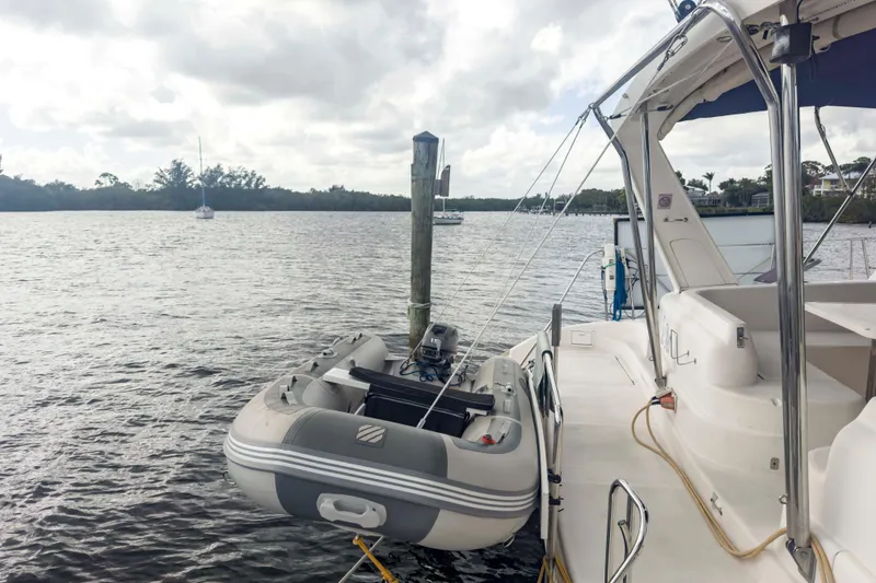 Slide: The Image of Leopard 42 catamaran from 2002 with dinghy, moored on a calm river. - 10