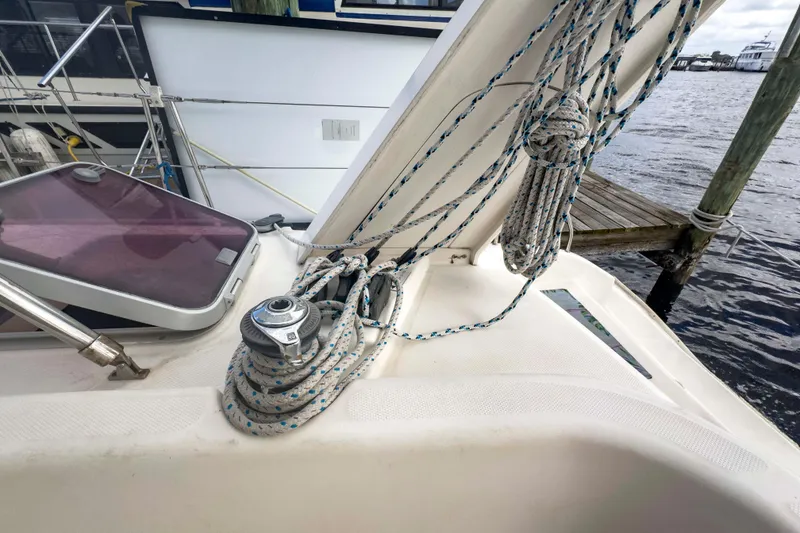 Slide: The Image of Leopard 42 sailboat deck with ropes and winch, docked by the water. - 12
