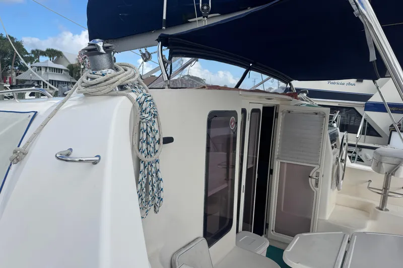 Slide: The Image of 2002 Leopard 42 catamaran deck with ropes and open cabin door. - 13