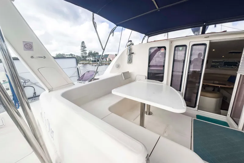 Slide: The Image of 2002 Leopard 42 yacht with outdoor seating and table, docked at marina. - 14