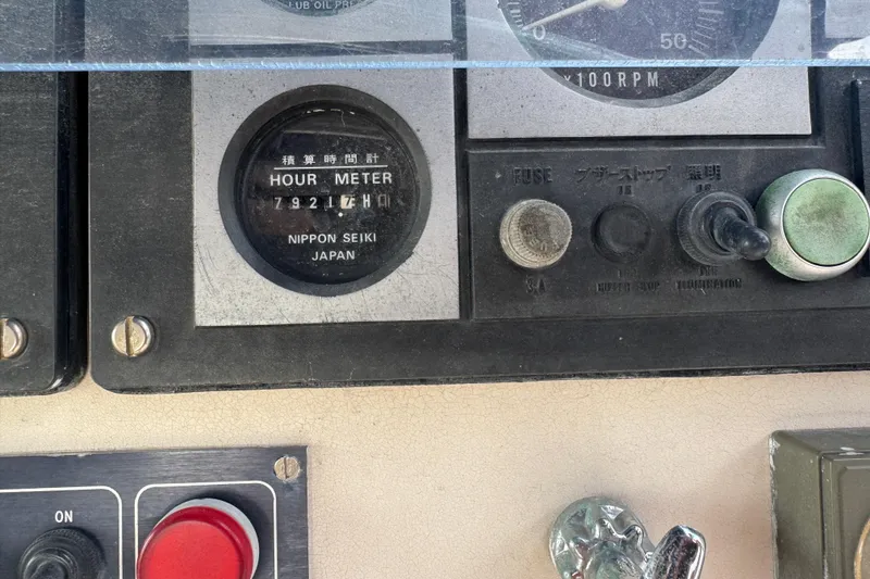 Slide: The Image of Control panel of a 2002 Leopard 42 with hour meter and switches. - 17