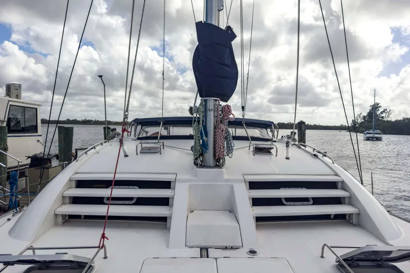 Slide: The Image of 2002 Leopard 42 catamaran docked, showcasing deck and rigging under cloudy sky. - 19