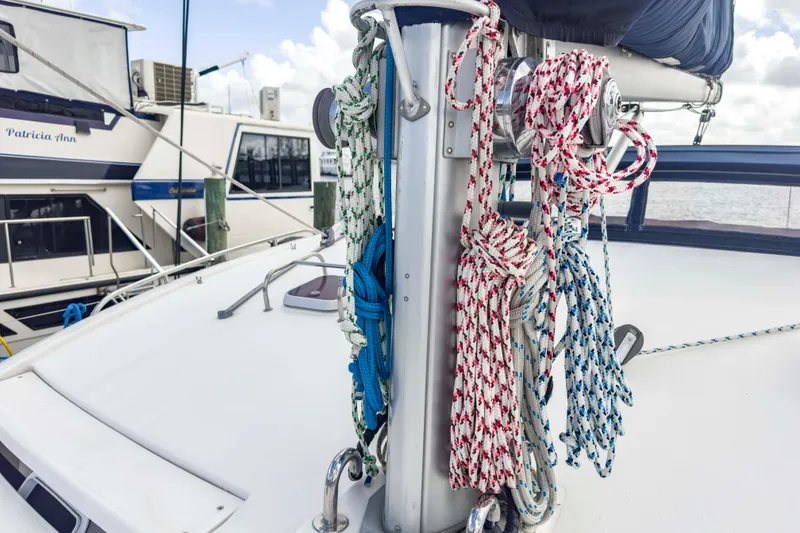 Slide: The Image of Sailboat deck with colorful ropes, Leopard 42 model, docked near other boats. - 20