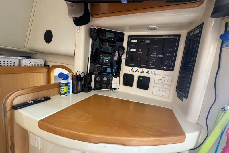 Slide: The Image of Navigation station on a 2002 Leopard 42 catamaran with communication equipment and control panels. - 38