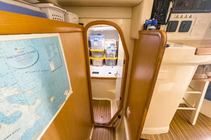 Slide: The Image of Interior of 2002 Leopard 42 yacht with Bahamas map and storage area. - 40
