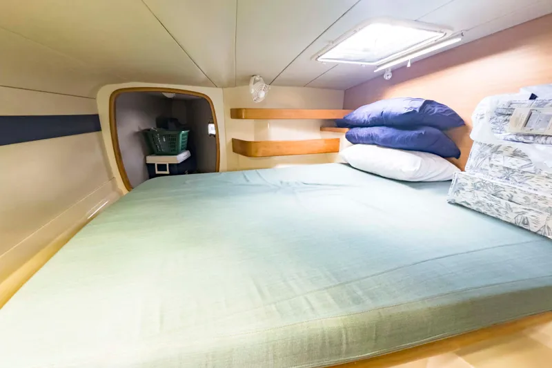 Slide: The Image of Cozy cabin interior of 2002 Leopard 42 yacht with bed and storage. - 45