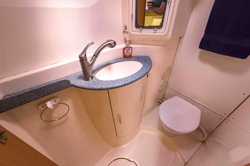 Slide: The Image of Compact bathroom in a 2002 Leopard 42 yacht with sink and toilet. - 47