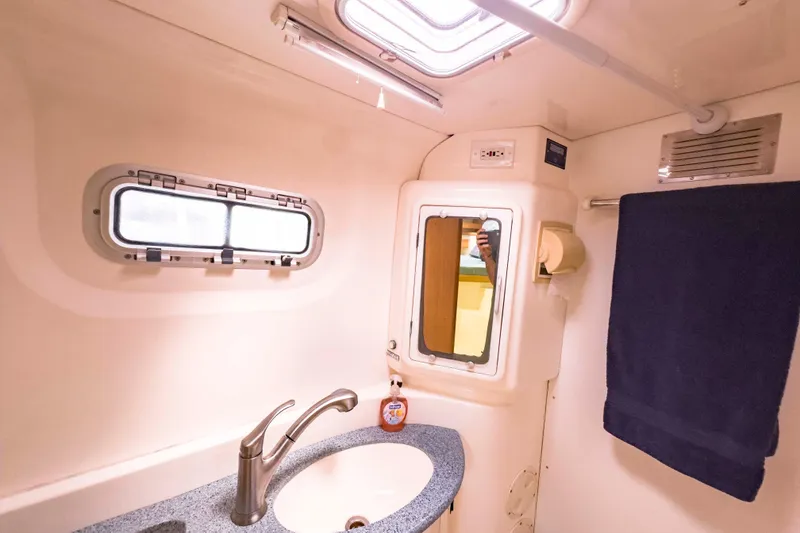 Slide: The Image of Bathroom interior of 2002 Leopard 42 yacht with sink, mirror, and towel. - 48