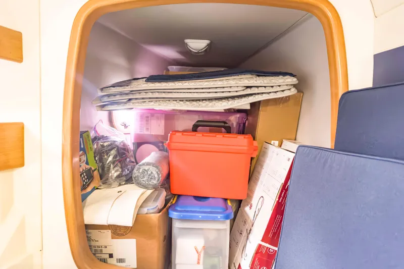 Slide: The Image of Storage compartment in a 2002 Leopard 42 yacht, filled with various items and equipment. - 50