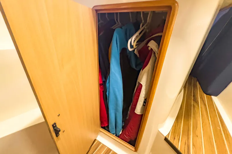 Slide: The Image of Wooden closet with hanging jackets inside a 2002 Leopard 42 yacht. - 51