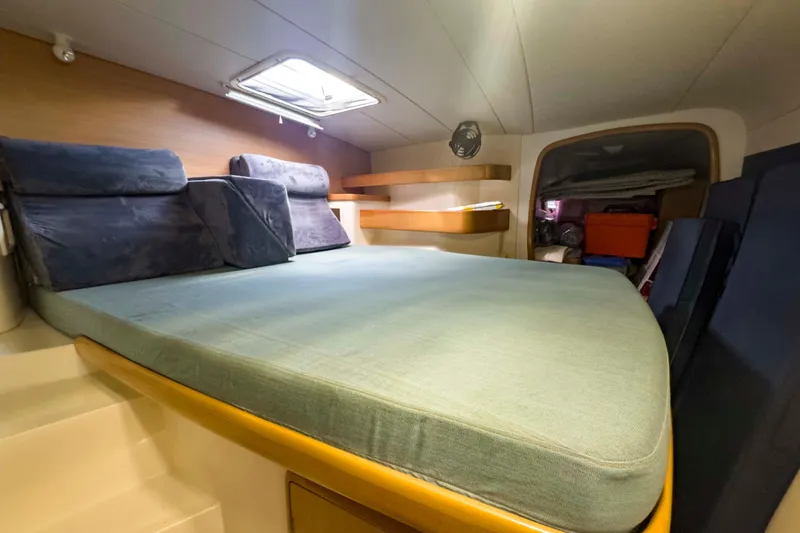 Slide: The Image of Cozy cabin interior of 2002 Leopard 42 yacht with comfortable bedding and storage. - 52