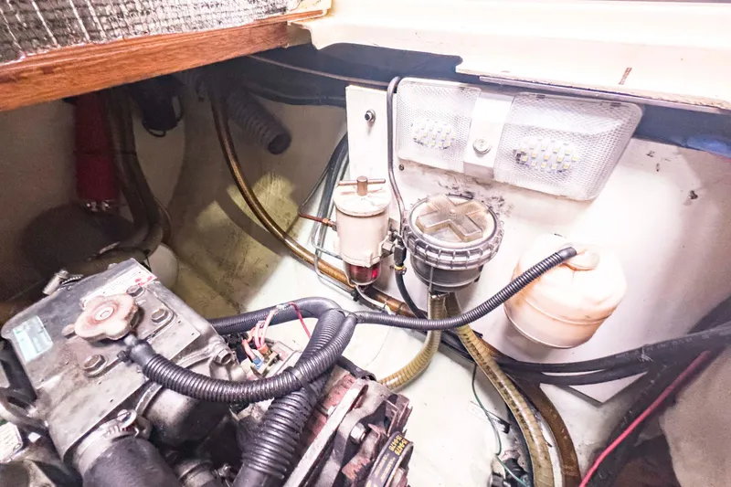 Slide: The Image of Engine compartment of a 2002 Leopard 42 yacht, showing mechanical components and wiring. - 53