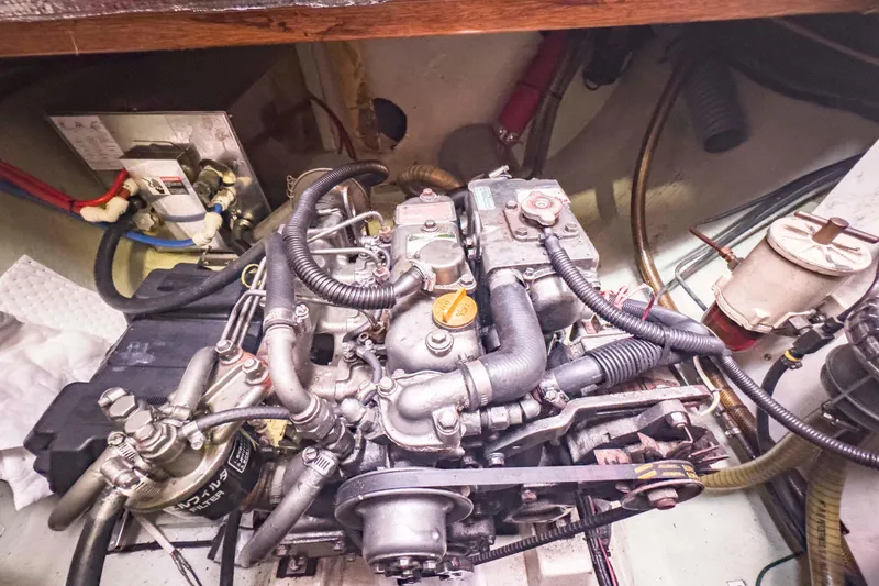 Slide: The Image of Engine compartment of a 2002 Leopard 42 yacht, showcasing detailed mechanical components. - 54