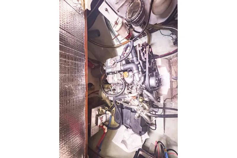 Slide: The Image of Engine compartment of a 2002 Leopard 42 yacht, showcasing intricate mechanical components. - 56