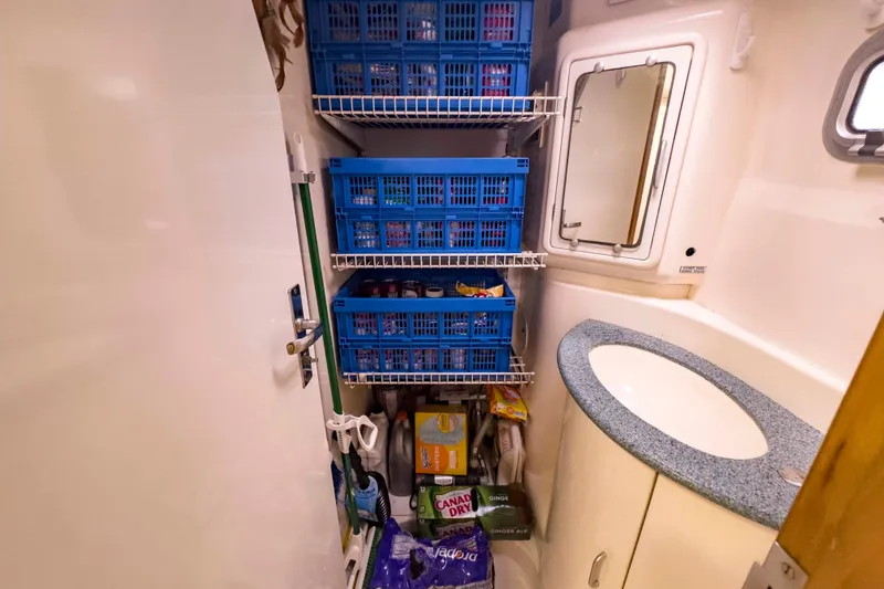 Slide: The Image of Storage area in a 2002 Leopard 42 yacht with organized shelves and supplies. - 58