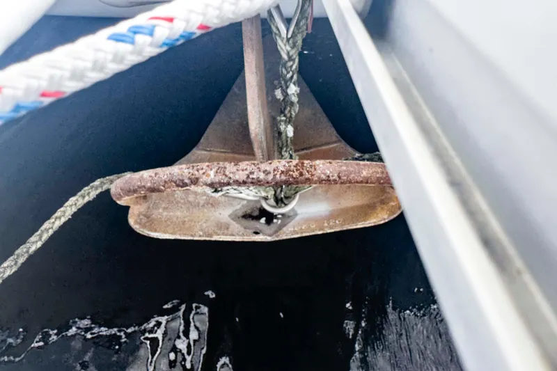 Slide: The Image of Rusty anchor on a Leopard 42 boat, 2002 model, with ropes attached. - 63