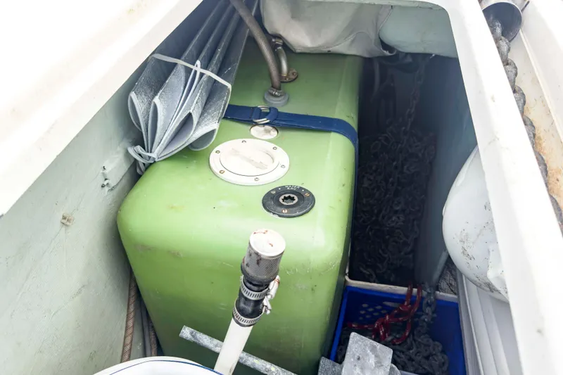 Slide: The Image of Storage compartment of a 2002 Leopard 42 boat with green tank and chains. - 67