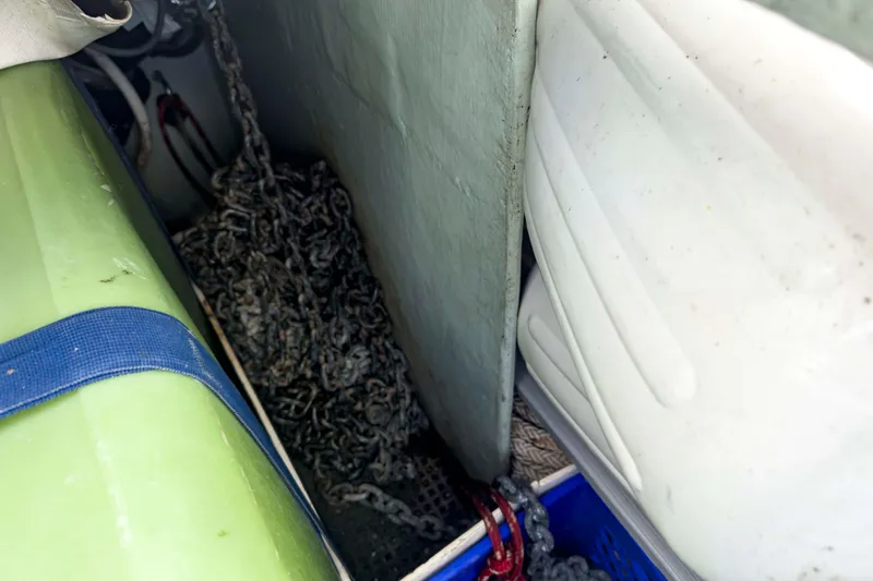 Slide: The Image of Storage compartment on a 2002 Leopard 42 boat with chains and equipment. - 68