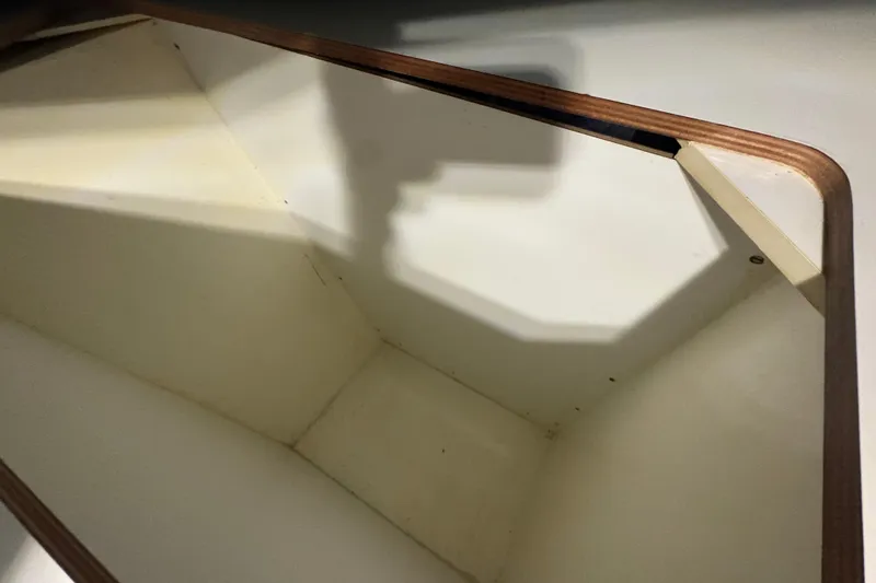 Slide: The Image of Interior compartment of a 2002 Leopard 42 boat, featuring wooden trim and white walls. - 74