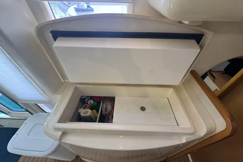 Slide: The Image of Interior view of a 2002 Leopard 42 yacht's storage compartment with various items. - 76