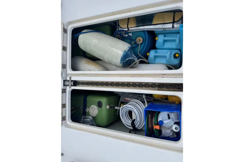 Slide: The Image of Storage compartment of a 2002 Leopard 42 yacht filled with marine equipment and supplies. - 80