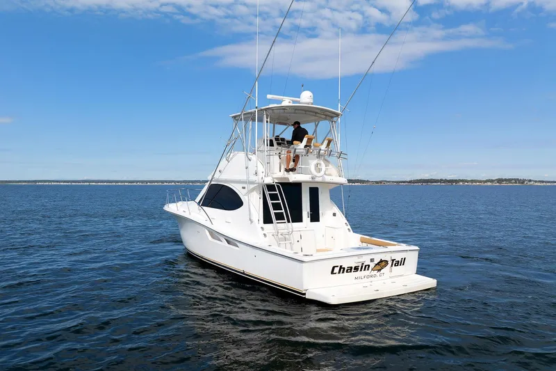Slide: The Image of 2007 Tiara Yachts 3900 Convertible on open water, clear sky background. - 19