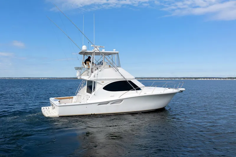 Slide: The Image of 2007 Tiara Yachts 3900 Convertible cruising on open water under blue sky. - 5