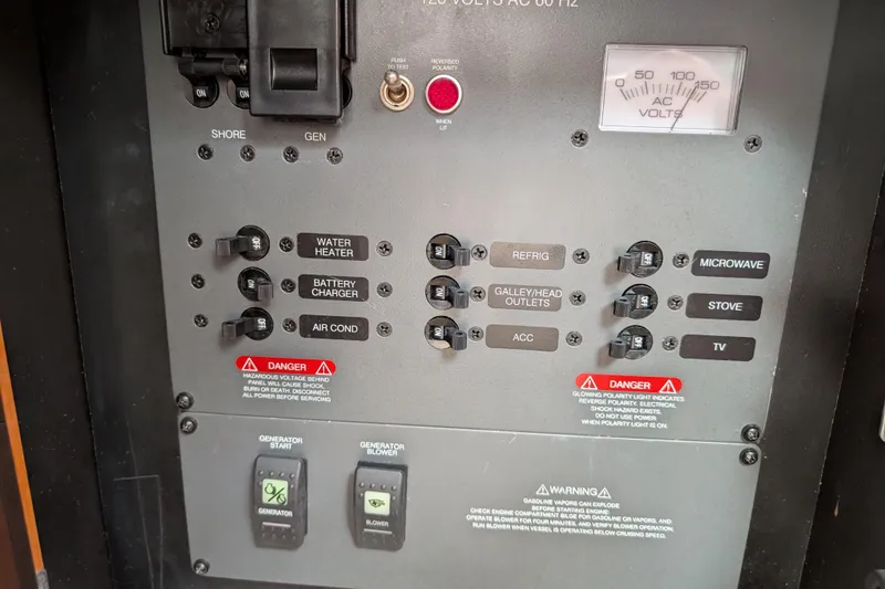 Slide: The Image of Electrical control panel of 2010 Robalo R305 Walkaround boat with various switches and warnings. - 16