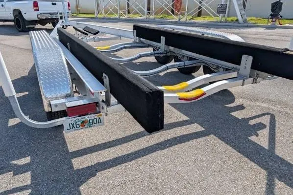 Slide: The Image of Trailer for 2010 Robalo R305 Walkaround boat, parked on pavement. - 18