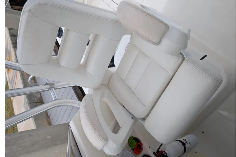 Slide: The Image of White seating on 2010 Robalo R305 Walkaround boat, featuring sleek design and comfort. - 5